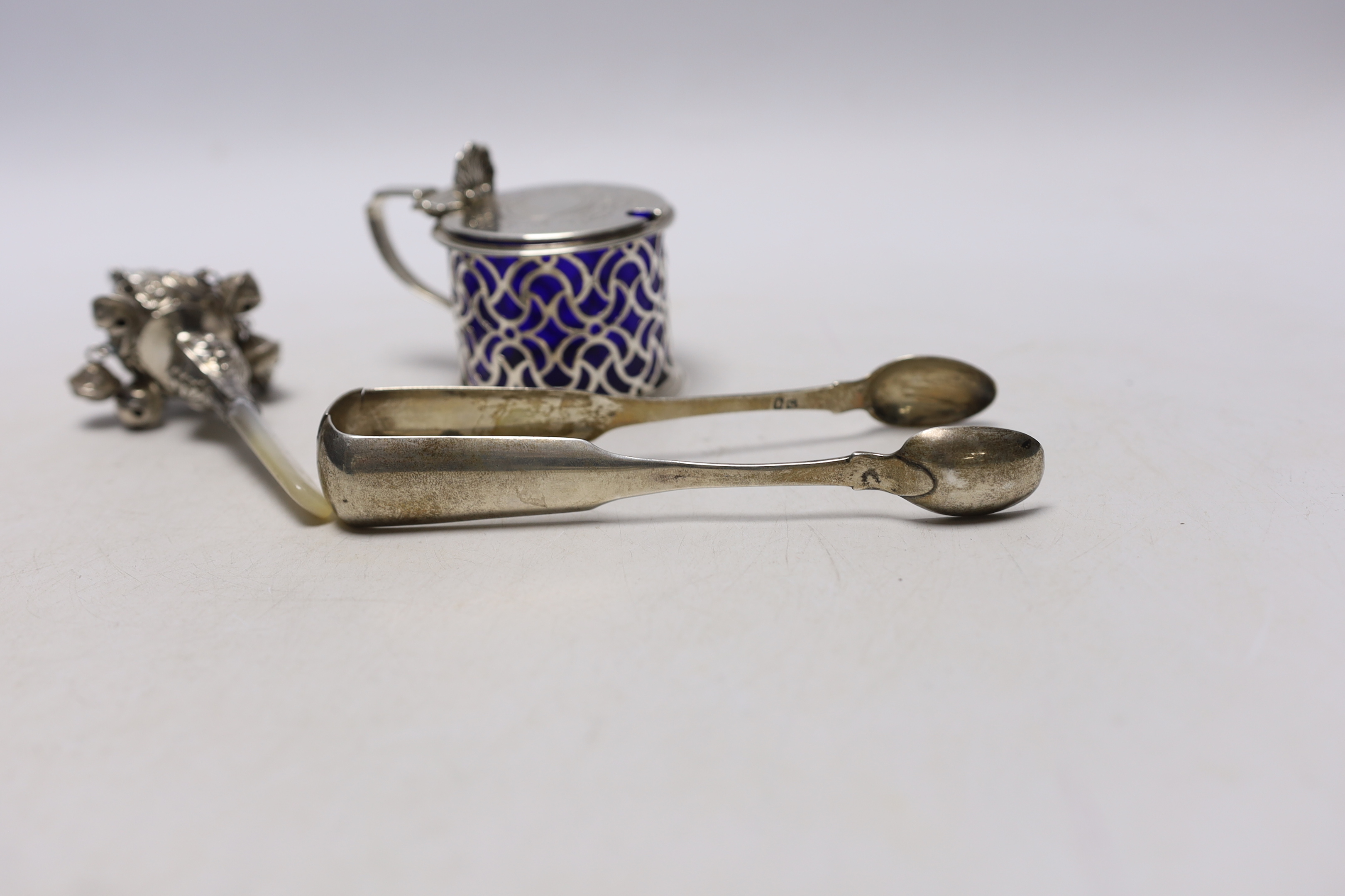 A Victorian pierced silver drum mustard pot, Charles & George Fox, London, 1854, a pair of 19th century Scottish provincial silver fiddle pattern sugar tongs, by David Gray of Dumfries, circa 1825 and a mother of pearl m